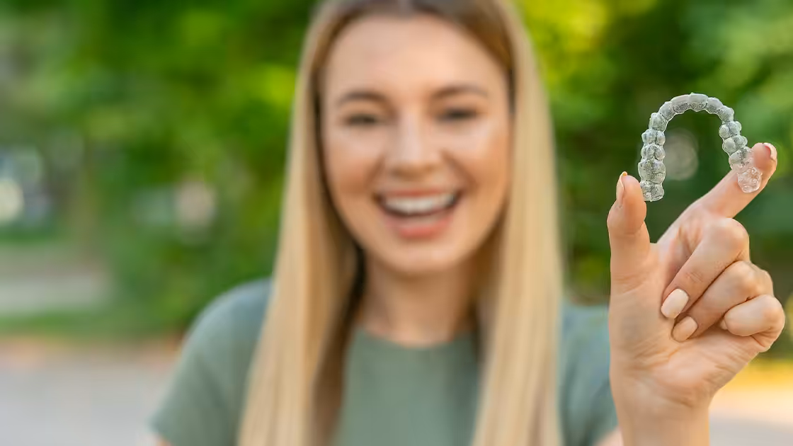 Woman holdoing invisalign